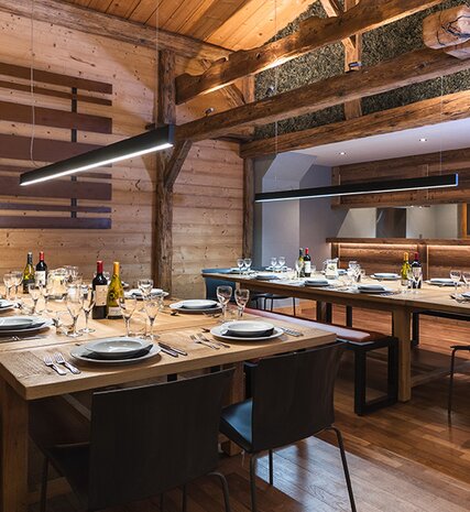 Two dining tables laid up for dinner in the chalet