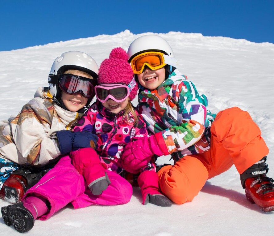 Three children on the slopes on a ski holiday