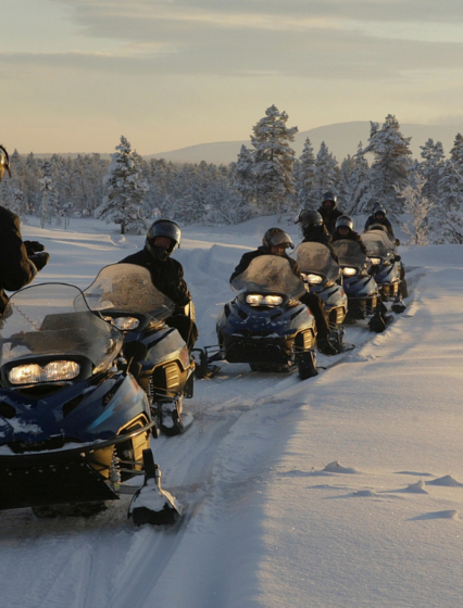 Group of people on snowmobile tour