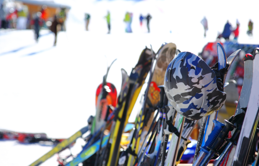 Skis and helmets lined up outside mountain restaurant