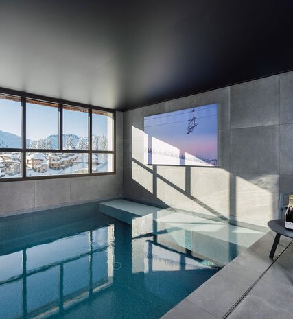 Indoor swimming pool with view of snowy Avoriaz in Chalet Ipaka, Val d'Isere