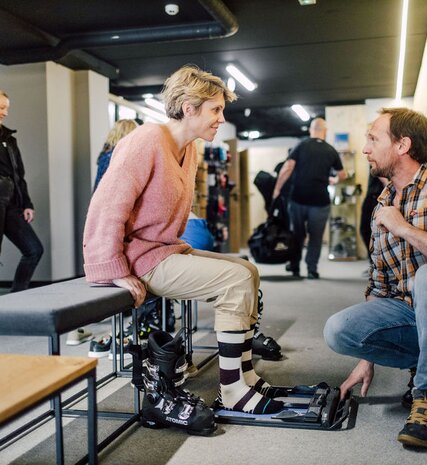 Woman being measured up for ski boots in Bear Lodge boot room