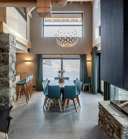 Contemporary open plan kitchen dining area with large table and fireplace