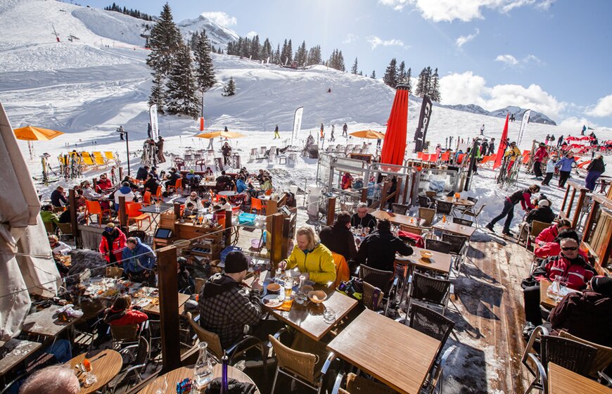 Busy outdoor terrace in Avoriaz with views of ski slopes