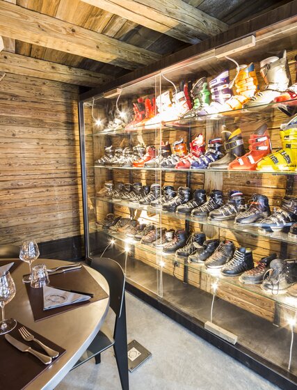 Display of ski boots over the years behind table in the restaurant
