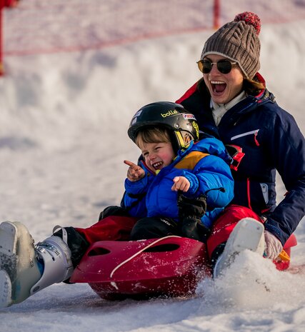 Mother and son sledging