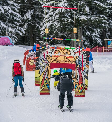 Family skiing on fun piste for children in Les Gets