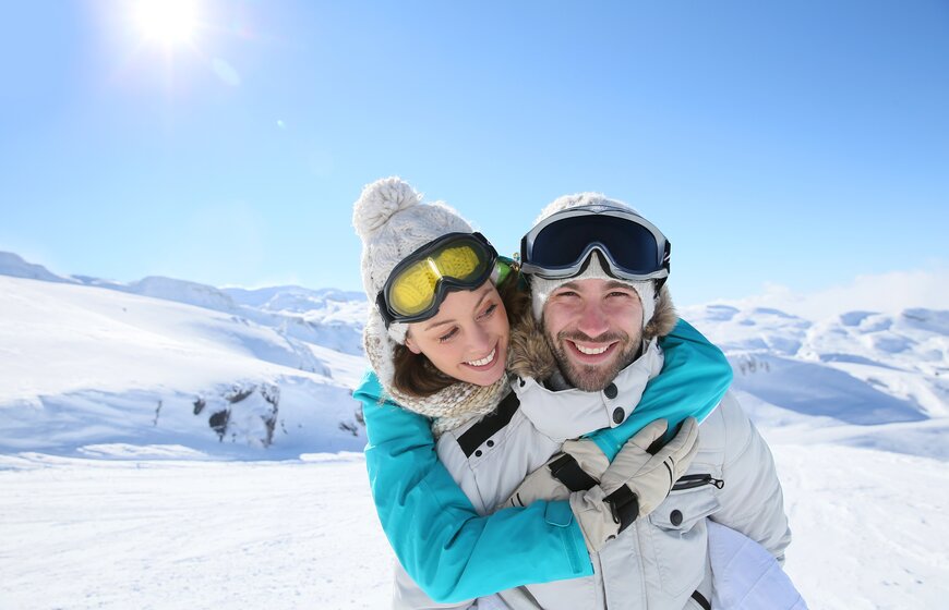 Smiling couple on ski holiday