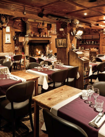 Interior of mountain restaurant Le Matafan in La Plagne with tables ready for evening service