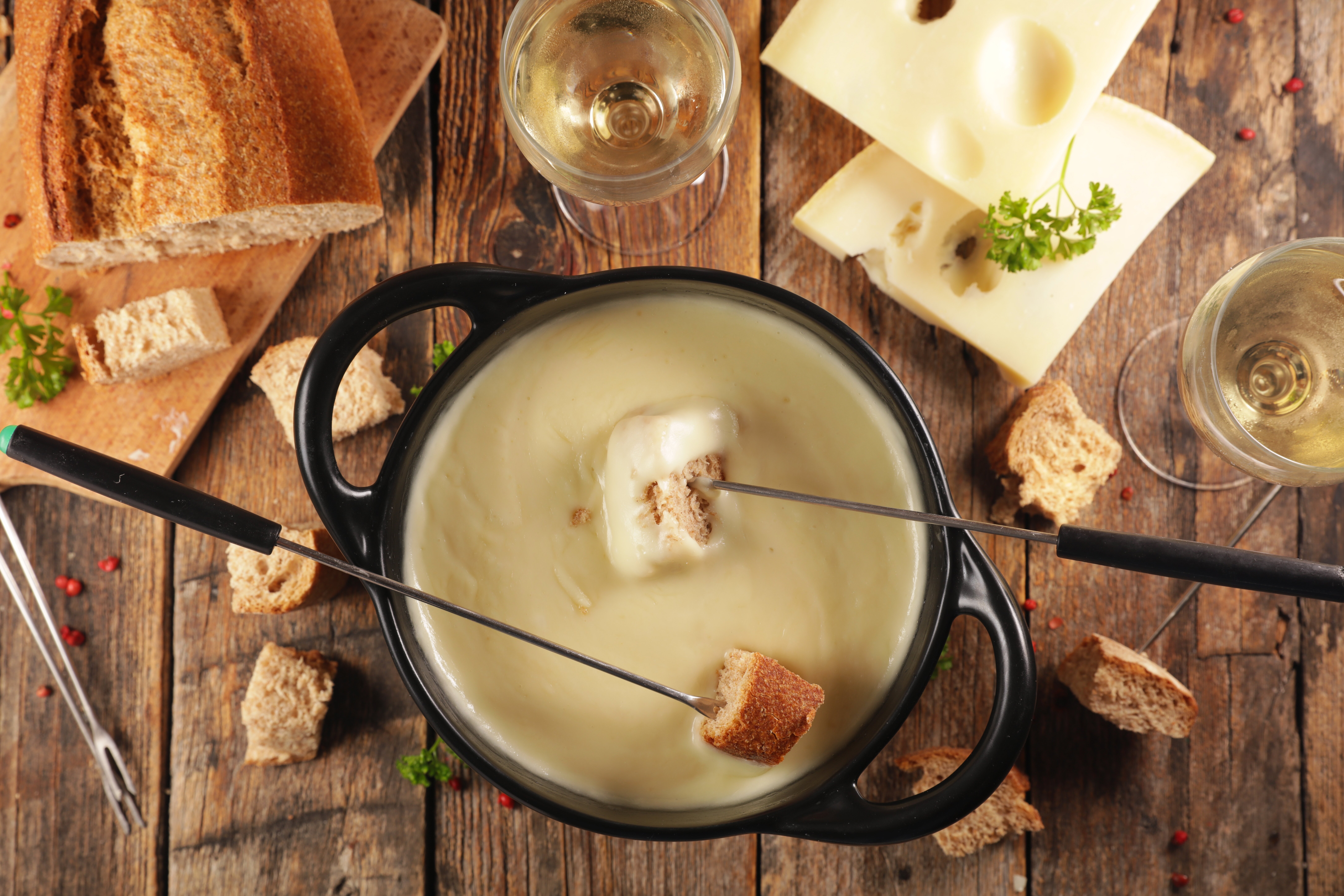 Cheese fondue with cubes of bread and white wine