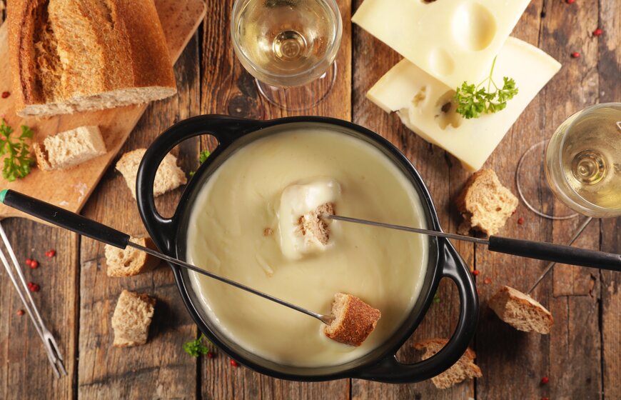 Cheese fondue with cubes of bread and white wine