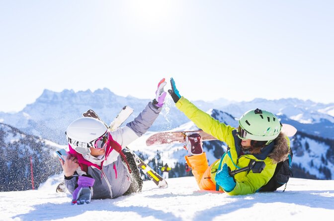 two female friends in the snow with ski equipment