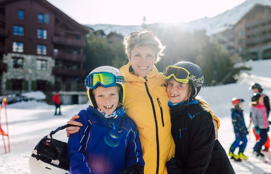 Mother, son and daughter smiling outside Bear Lodge in Arc 1950