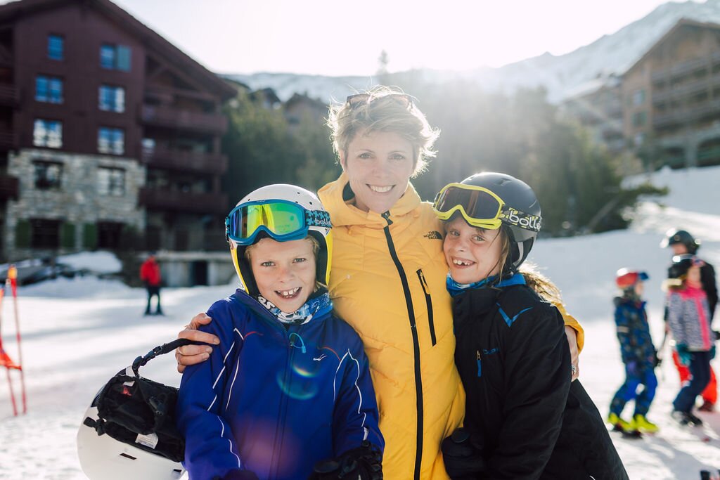 Mum and two children on a ski holiday, outside Bear Lodge, Arc 1950