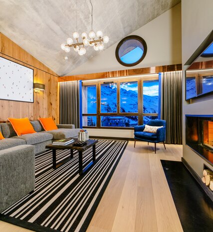 Contemporary living area with roaring fire in VIP SKI luxury chalet in Avoriaz