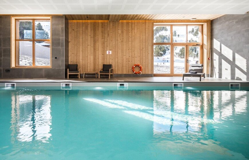 Hotel swimming pool with views of the ski slopes from the windows