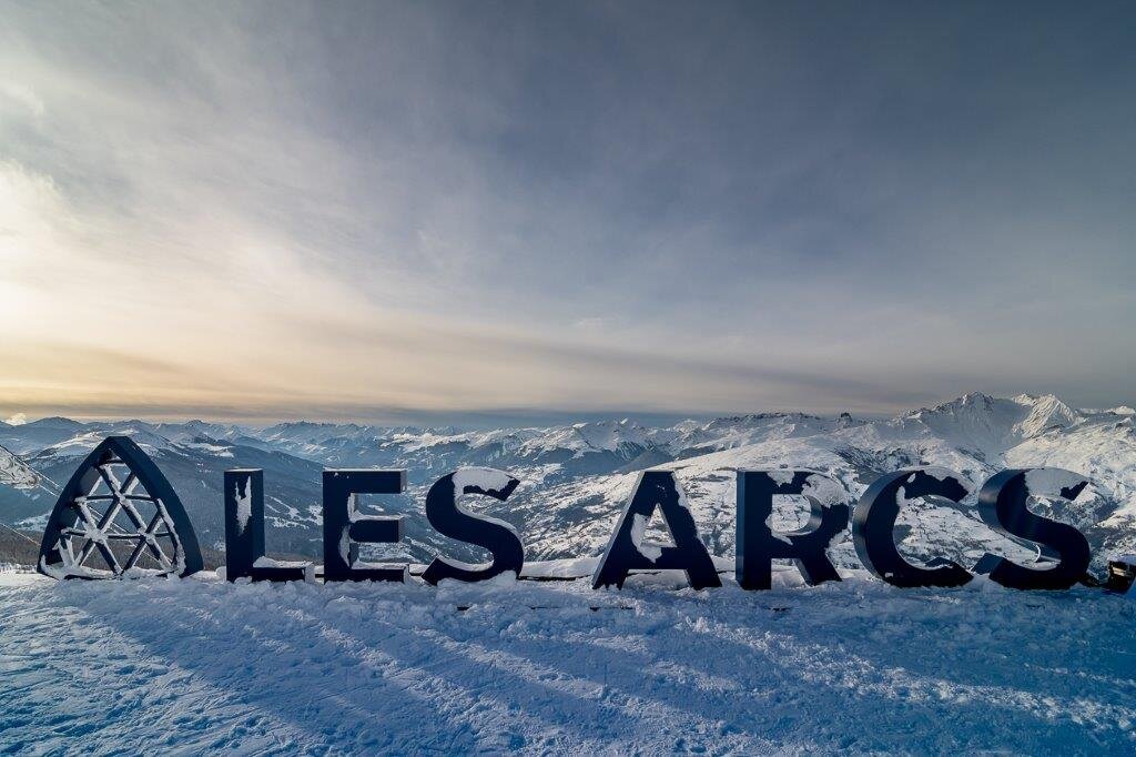 Les Arcs sign, large letters spelling the ski resort with snow covering